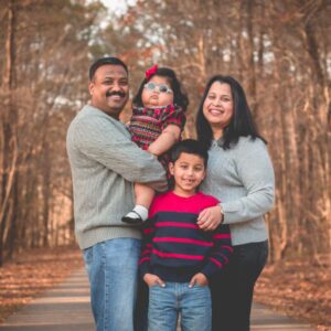 Krishnan family standing on a path in the woods